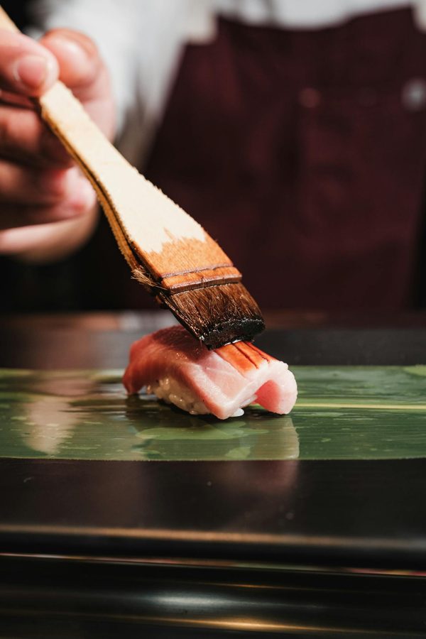 Nigiri brushed with soy at the counter